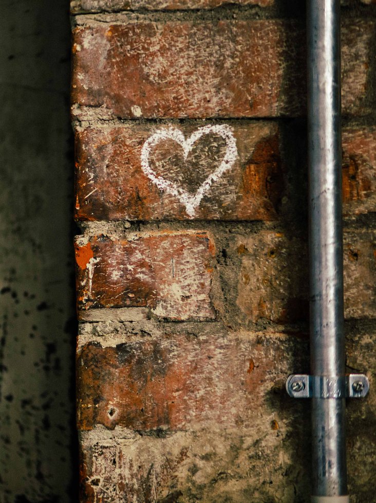 Theaterhaus typical brickstone wall with a drawn chalk heart on it