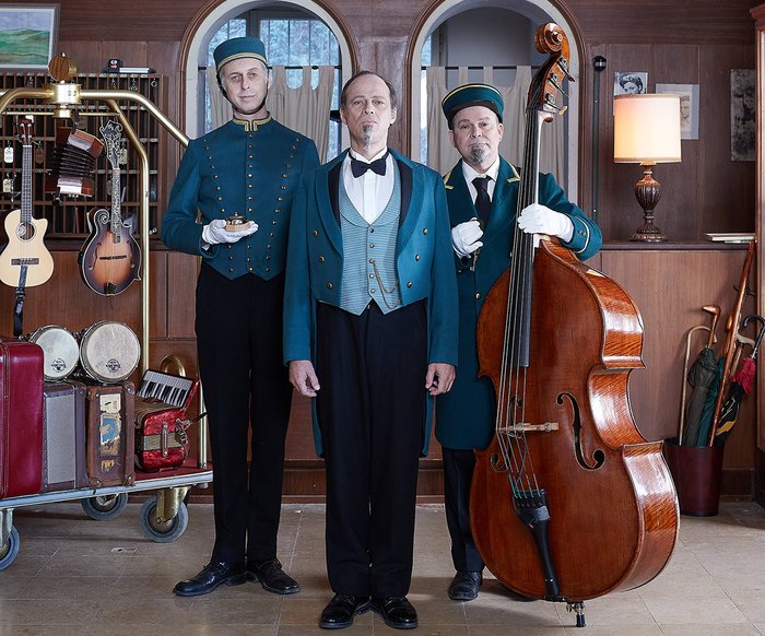 Drei Männer mit Instrumenten in einem Hotel